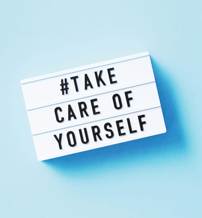 Take Care Of Yourself Written White Lightbox Sitting On Blue Background